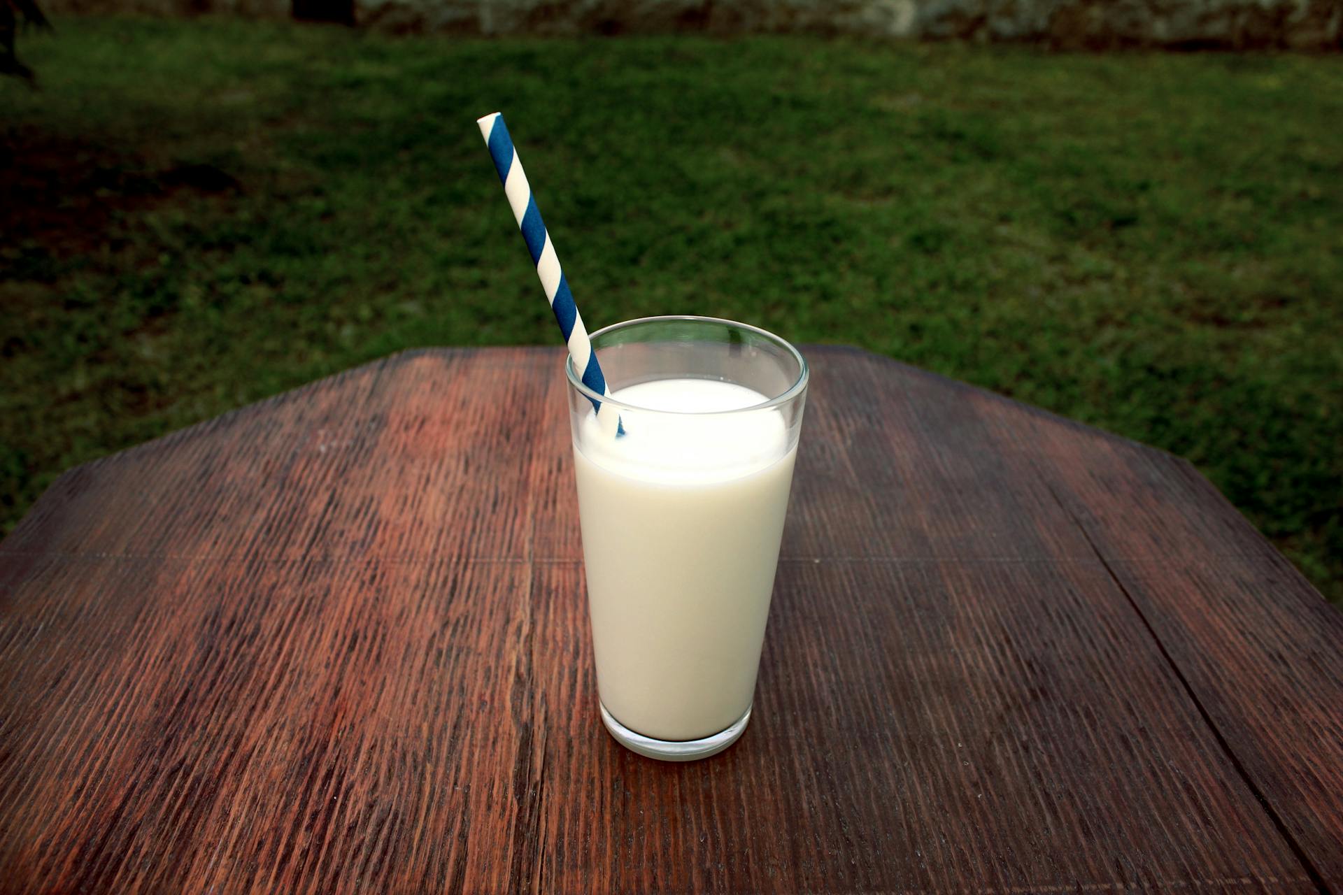 Glass of cold milk on a kitchen counter &mdash; conventional vs grass-fed dairy comparison