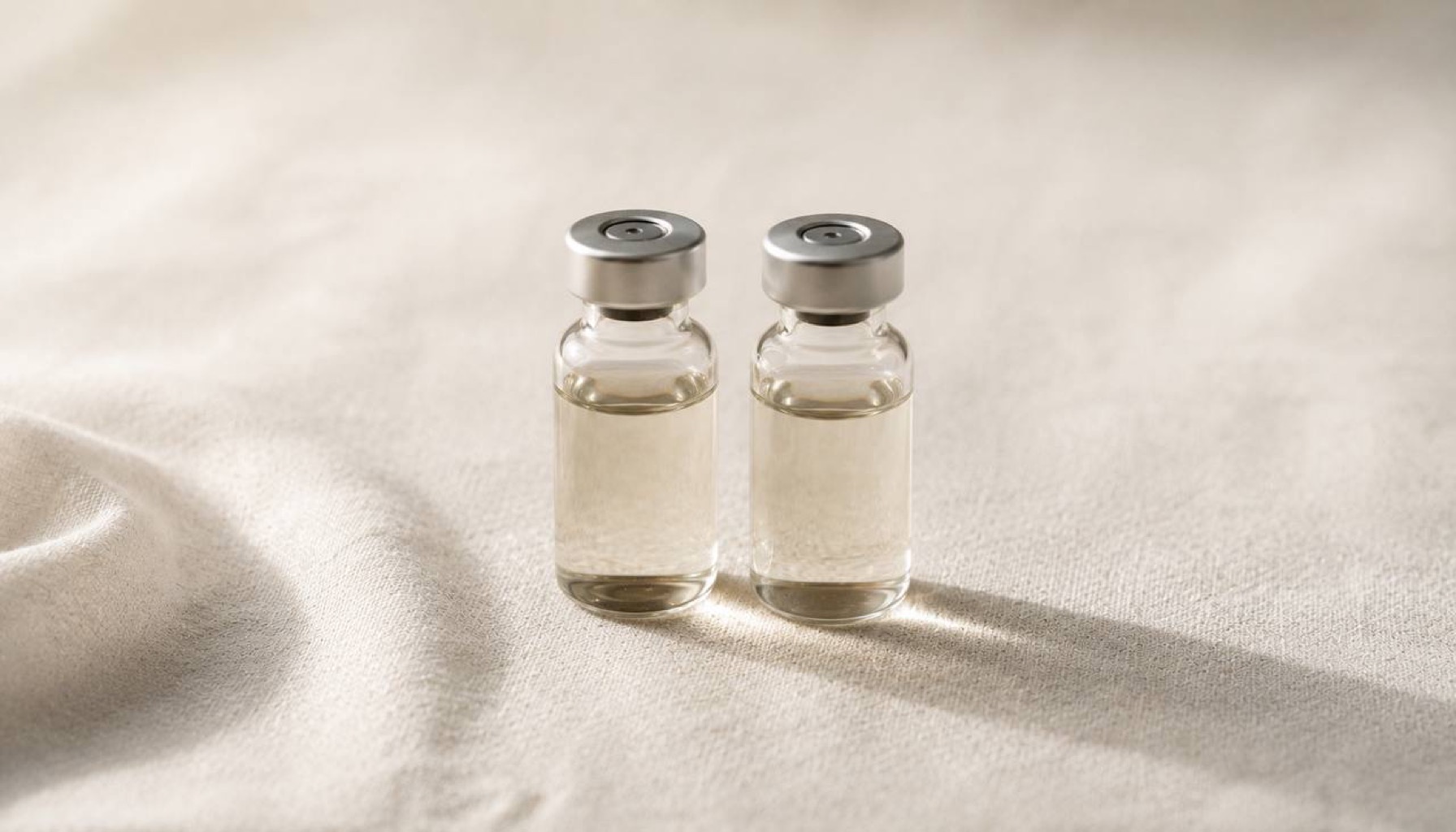 Testosterone vial and syringe on clinical surface — hormone therapy pharmacology
