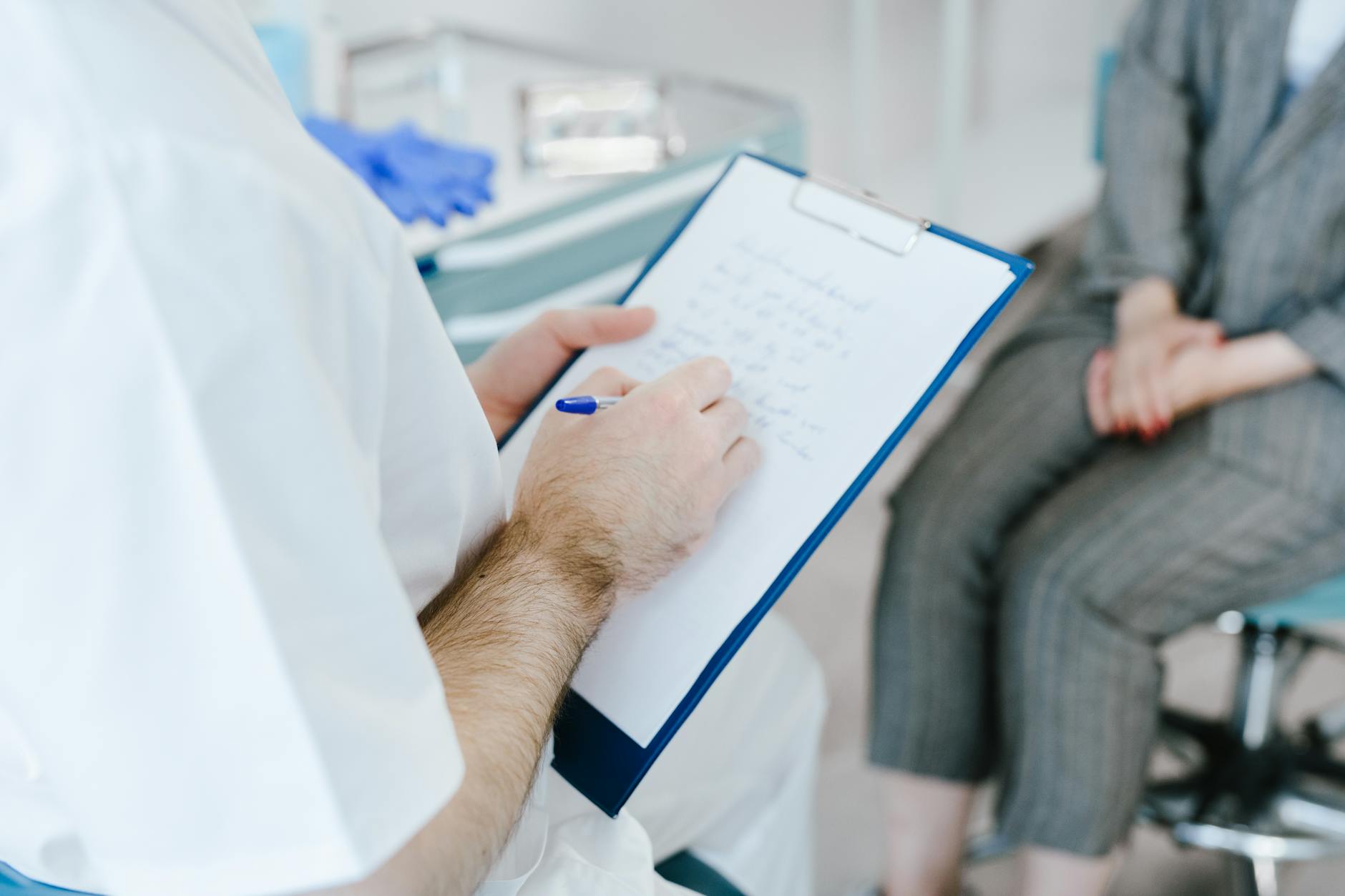 Neurologist with patient in clinical setting — Parkinson's disease research and treatment