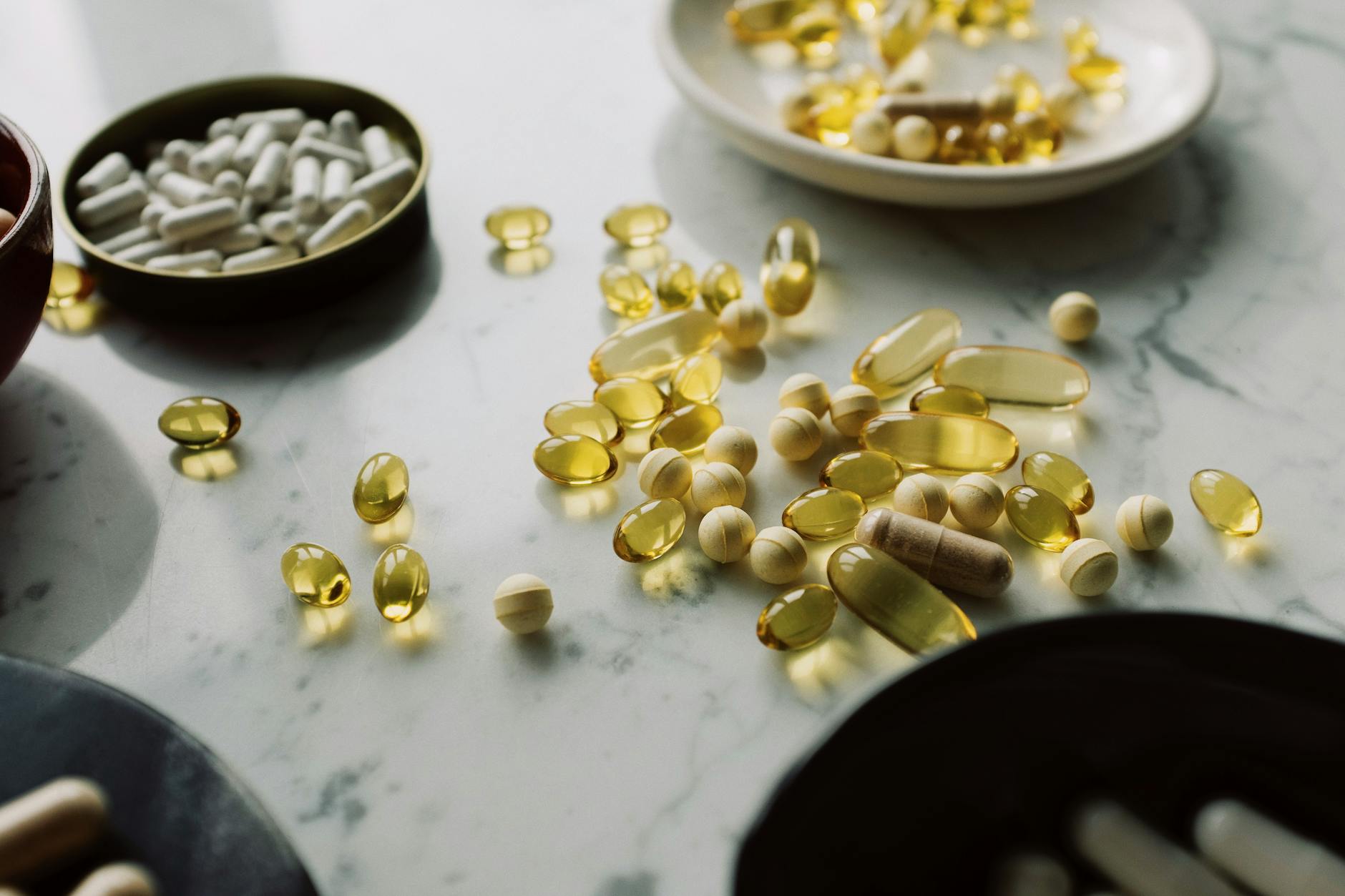 Assorted supplement capsules and softgels — glycine NAC amino acid supplements for glutathione and longevity research